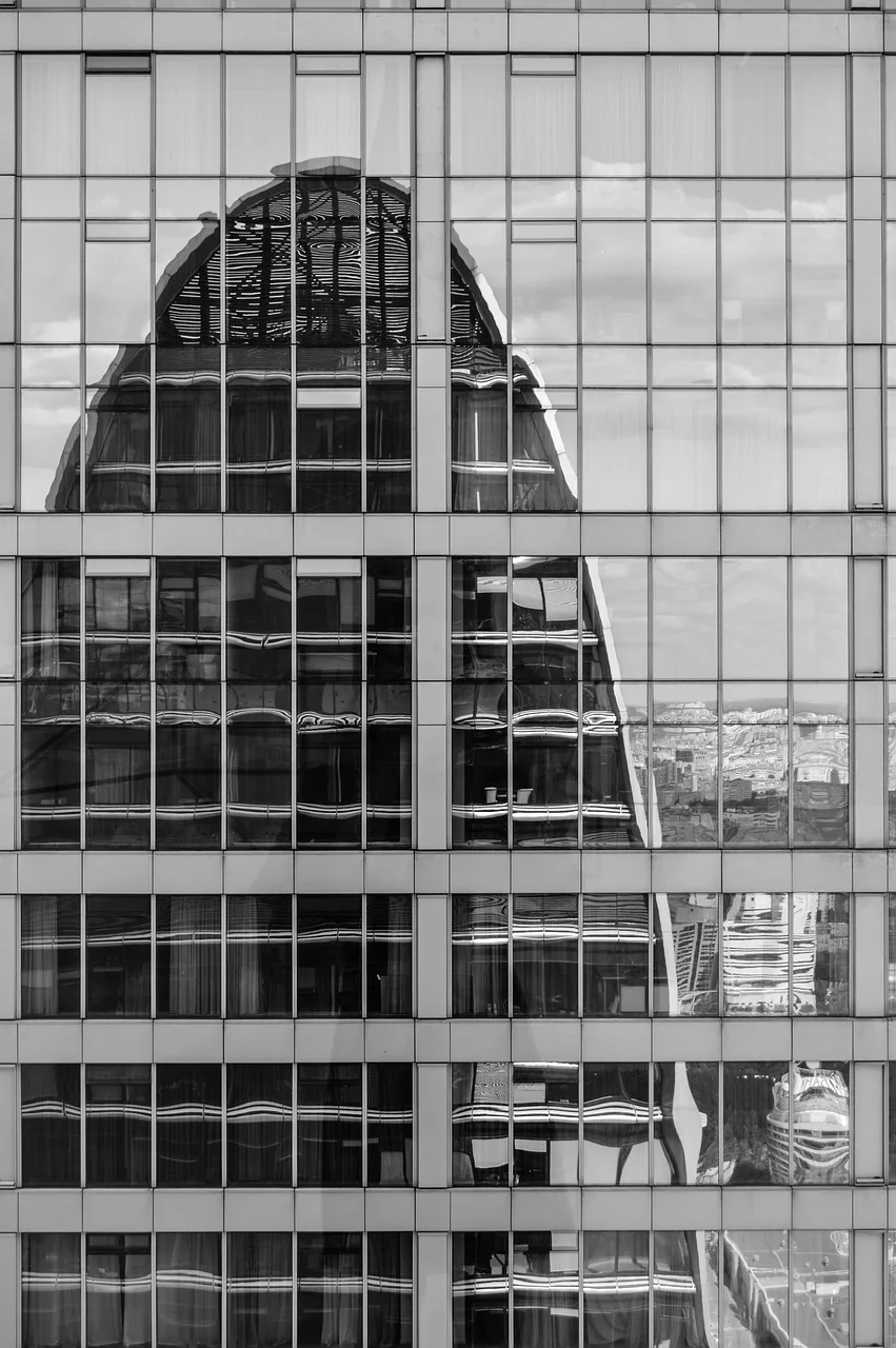“Facilities inspector walking through a commercial building while using inspection software on a tablet to document structural and mechanical conditions.”